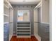 Spacious walk-in closet featuring custom shelving, drawers, and ample storage at 1650 S Holly St, Denver, CO 80222