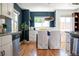 Bright dining room features hardwood floors, a modern light fixture and dark blue accent wall at 1650 S Holly St, Denver, CO 80222