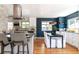 Modern kitchen and dining area featuring stainless steel appliances, updated counters, and hardwood floors at 1650 S Holly St, Denver, CO 80222