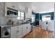 Bright kitchen features white cabinets, stainless steel appliances, and granite countertops at 1650 S Holly St, Denver, CO 80222