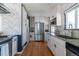 Modern kitchen with stainless steel appliances, sleek countertops, and ample cabinet space at 1650 S Holly St, Denver, CO 80222