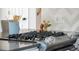 Close up on a kitchen cooktop with modern appliances and a light tile backsplash at 1650 S Holly St, Denver, CO 80222