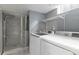 A modern laundry room with a glass-enclosed shower and new appliances at 1650 S Holly St, Denver, CO 80222