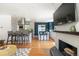 Open-concept living space with modern kitchen, dining area, and a fireplace at 1650 S Holly St, Denver, CO 80222