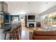 Stylish living space with modern fireplace, breakfast bar, and stainless steel appliances at 1650 S Holly St, Denver, CO 80222