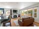 Bright living room featuring a modern fireplace, hardwood floors, and an open layout at 1650 S Holly St, Denver, CO 80222