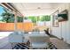 Relaxing covered patio with comfortable seating, stylish rug, and view of the fenced backyard at 1650 S Holly St, Denver, CO 80222