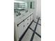 Modern bathroom featuring a double sink vanity and a soaking tub with tiled surround at 7255 E Quincy Ave # 205, Denver, CO 80237