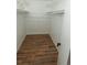Walk-in closet featuring rod and wire shelving, complemented by modern wood-look flooring at 7255 E Quincy Ave # 205, Denver, CO 80237