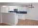 Bright kitchen with white cabinets, dark hardware, and an eat-in breakfast bar at 7255 E Quincy Ave # 205, Denver, CO 80237