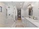 Luxurious bathroom featuring a glass shower, double vanity, and closet at 354 Milwaukee St, Denver, CO 80206