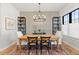 Well-lit dining room featuring a wooden table, ornate chandelier, and stylish decor at 354 Milwaukee St, Denver, CO 80206
