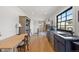 Hallway with a long countertop and cabinets with a window and a table and chair at 354 Milwaukee St, Denver, CO 80206