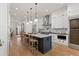 Modern kitchen with stainless steel appliances, large island, and stylish pendant lighting at 354 Milwaukee St, Denver, CO 80206
