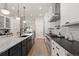 Open concept kitchen with white cabinets, stainless steel appliances, and a breakfast bar at 354 Milwaukee St, Denver, CO 80206