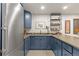 Basement kitchenette with stainless steel appliances and blue cabinets at 354 Milwaukee St, Denver, CO 80206