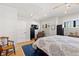 Bright main bedroom featuring a large bed, hardwood floors, and ample natural light at 354 Milwaukee St, Denver, CO 80206