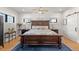 Spacious main bedroom with a large bed, ceiling fan, and hardwood floors at 354 Milwaukee St, Denver, CO 80206