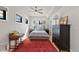 Comfortable bedroom with a ceiling fan, bright windows, and stylish furniture on a red area rug at 354 Milwaukee St, Denver, CO 80206