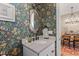Charming powder room with patterned wallpaper and marble vanity at 354 Milwaukee St, Denver, CO 80206