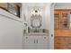 Charming powder room featuring a vanity, mirror, and a nearby wooden cabinet at 354 Milwaukee St, Denver, CO 80206
