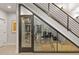 Modern wine cellar built under stairs, showcasing a collection of wines with glass enclosure at 354 Milwaukee St, Denver, CO 80206