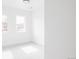 Bright, minimalist bedroom with two windows providing natural light and neutral colored carpet at 12575 W 10Th Ave, Golden, CO 80401