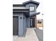 Stylish townhome entrance with blue siding, modern black door, and gravel landscaping at 12575 W 10Th Ave, Golden, CO 80401