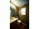 The bathroom features a wood floor, vanity, and a framed mirror over the sink at 9950 Sydney Ln, Highlands Ranch, CO 80130