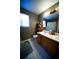 Bathroom featuring double sinks, neutral tiles, and a tub with shower at 9950 Sydney Ln, Highlands Ranch, CO 80130