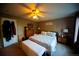 Comfortable bedroom with ceiling fan, closet, and well-lit with natural light at 9950 Sydney Ln, Highlands Ranch, CO 80130