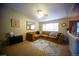 Cozy living room with a large sectional couch, a ceiling fan, and carpet flooring at 9950 Sydney Ln, Highlands Ranch, CO 80130
