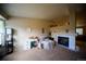 Spacious living room with a fireplace, neutral carpet, and a comfortable chair at 9950 Sydney Ln, Highlands Ranch, CO 80130