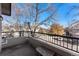 The open-air balcony features a stone table and wrought-iron railings at 8671 E Dry Creek Rd # 721, Englewood, CO 80112