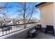 This condo balcony includes a table, chairs, and views of the street at 8671 E Dry Creek Rd # 721, Englewood, CO 80112