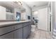 Bathroom with gray vanity, tiled floor, and a separate toilet area at 8671 E Dry Creek Rd # 721, Englewood, CO 80112