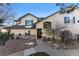 The property features tan siding, a sidewalk, and manicured landscaping at 8671 E Dry Creek Rd # 721, Englewood, CO 80112
