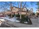 An exterior view of the condo showing the landscaping and parking areas at 8671 E Dry Creek Rd # 721, Englewood, CO 80112