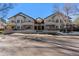 The condo complex has tan siding, brick accents, and covered parking at 8671 E Dry Creek Rd # 721, Englewood, CO 80112