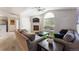 Cozy living room with a fireplace, vaulted ceiling, and large arched window at 8671 E Dry Creek Rd # 721, Englewood, CO 80112