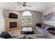 Cozy living room with a fireplace, large window, and comfortable sofas at 8671 E Dry Creek Rd # 721, Englewood, CO 80112