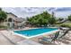 Relaxing community pool area with lounge chairs, tables, and lush landscaping at 8671 E Dry Creek Rd # 721, Englewood, CO 80112