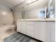 Bright bathroom featuring a tub and shower combination and a double sink vanity at 17037 E Wiley Pl, Parker, CO 80134