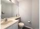 Cozy powder room with neutral tones, a large mirror, and a pedestal sink at 17037 E Wiley Pl, Parker, CO 80134