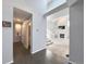 Hallway featuring hardwood flooring, leading to staircase and rooms with neutral paint and natural light at 17037 E Wiley Pl, Parker, CO 80134