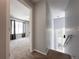 Hallway and staircase leading to a carpeted room with ample natural light at 17037 E Wiley Pl, Parker, CO 80134