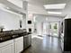 Modern kitchen with stainless steel appliances, dark countertops, and sunlit breakfast bar at 17037 E Wiley Pl, Parker, CO 80134