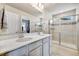 Bright bathroom features a double sink vanity and glass-enclosed shower at 8586 Holman Ct # A, Arvada, CO 80005