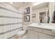 Neutral bathroom with a shower and tub featuring modern vanity and nautical themed art at 8586 Holman Ct # A, Arvada, CO 80005