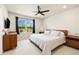 Bedroom with window overlooking a landscape, ceiling fan, and modern furnishings at 8586 Holman Ct # A, Arvada, CO 80005